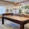 a large living room with a large table and chairs