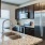 a kitchen with a stainless steel refrigerator