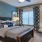 a bedroom with a bed and a fan