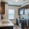 a kitchen with a stainless steel refrigerator