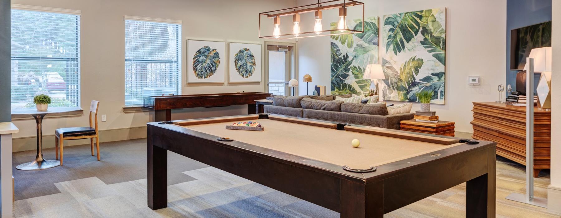 a large living room with a large table and chairs